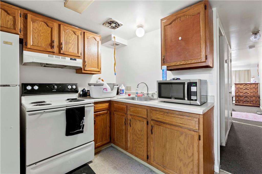 634 Broadway Avenue McKees Rocks, PA 15136 - Photo 17 of 40 a kitchen with stainless steel appliances granite countertop a stove and a sink