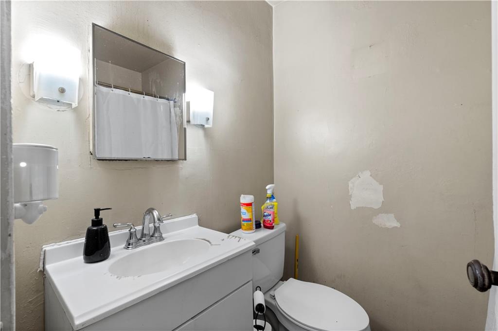 634 Broadway Avenue McKees Rocks, PA 15136 - Photo 18 of 40 a bathroom with a sink mirror and toilet