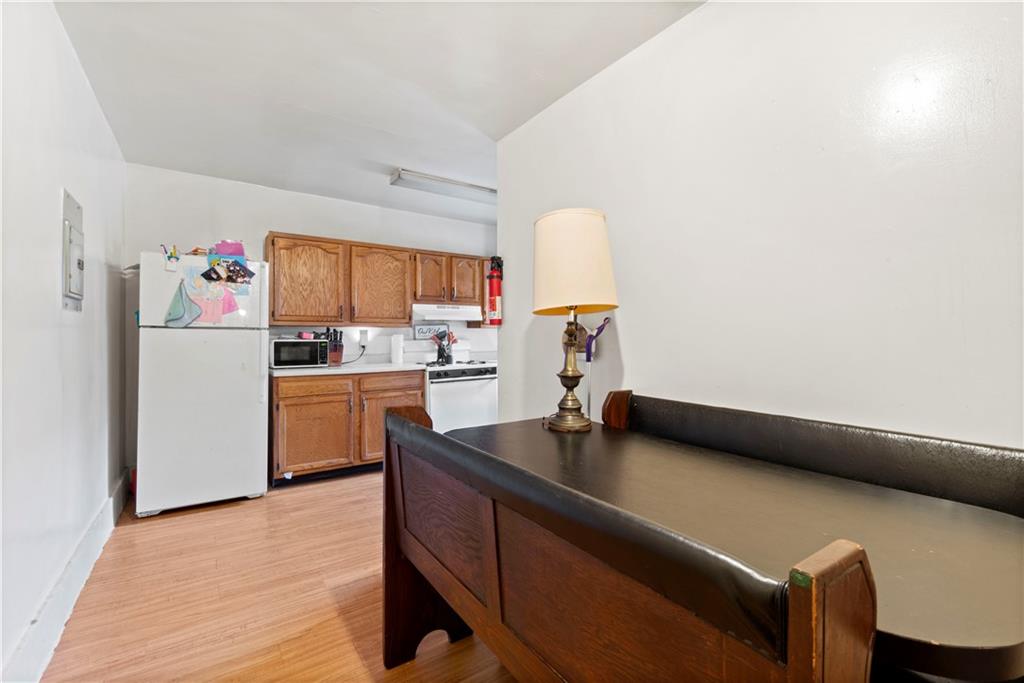 634 Broadway Avenue McKees Rocks, PA 15136 - Photo 20 of 40 a kitchen with a refrigerator and a stove top oven