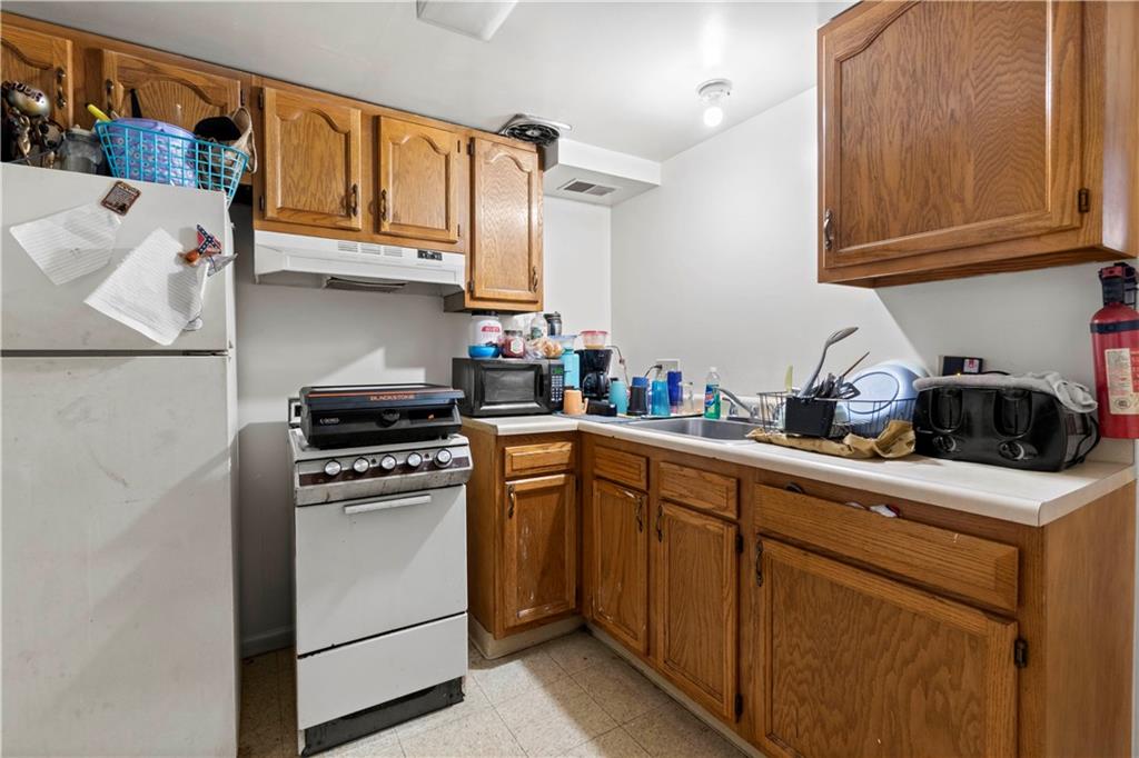 634 Broadway Avenue McKees Rocks, PA 15136 - Photo 23 of 40 a kitchen with stainless steel appliances granite countertop a sink and cabinets