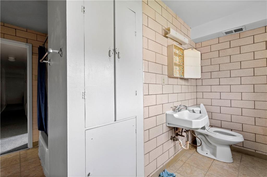 634 Broadway Avenue McKees Rocks, PA 15136 - Photo 38 of 40 a bathroom with a toilet and a sink