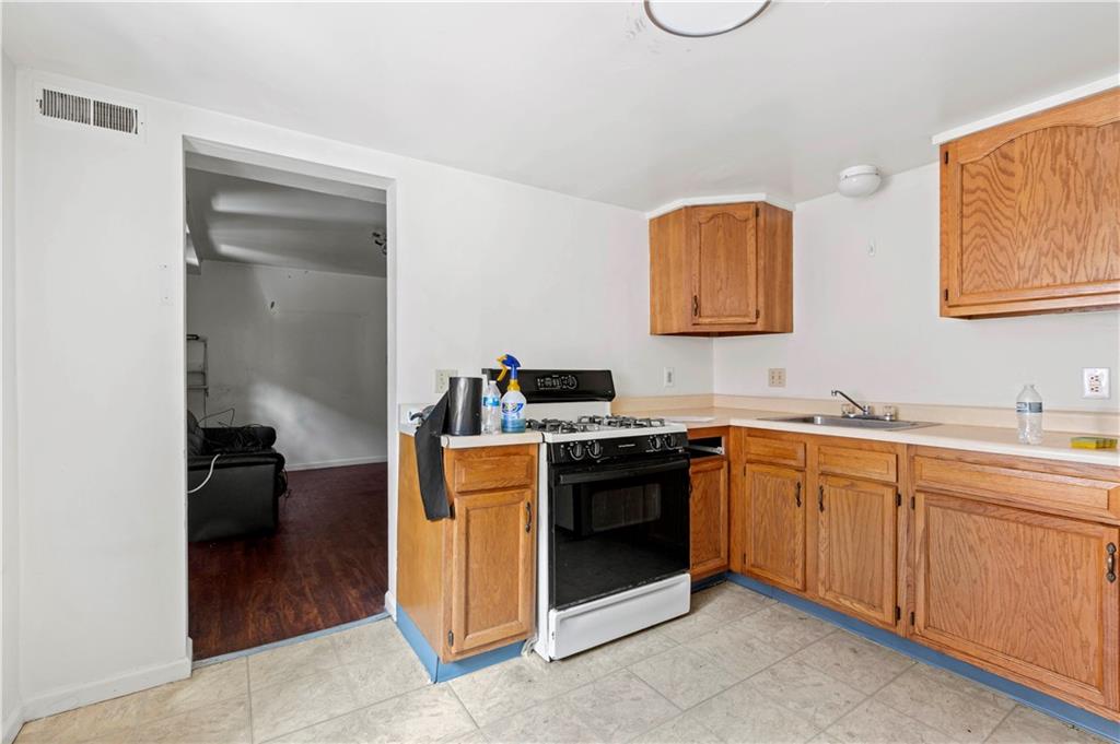 634 Broadway Avenue McKees Rocks, PA 15136 - Photo 40 of 40 a kitchen with stainless steel appliances granite countertop a stove and a sink