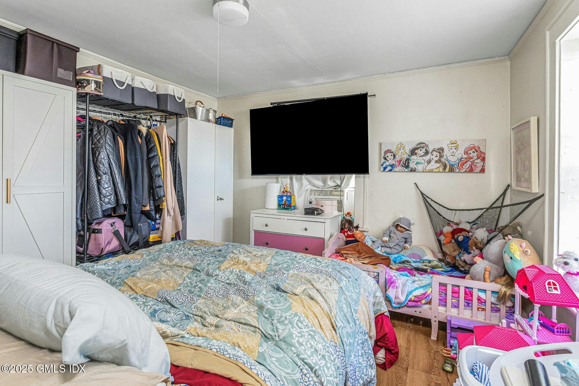 38 Alexander Street Greenwich, CT 06830 - Photo 19 of 36 a bedroom with a bed and a flat screen tv