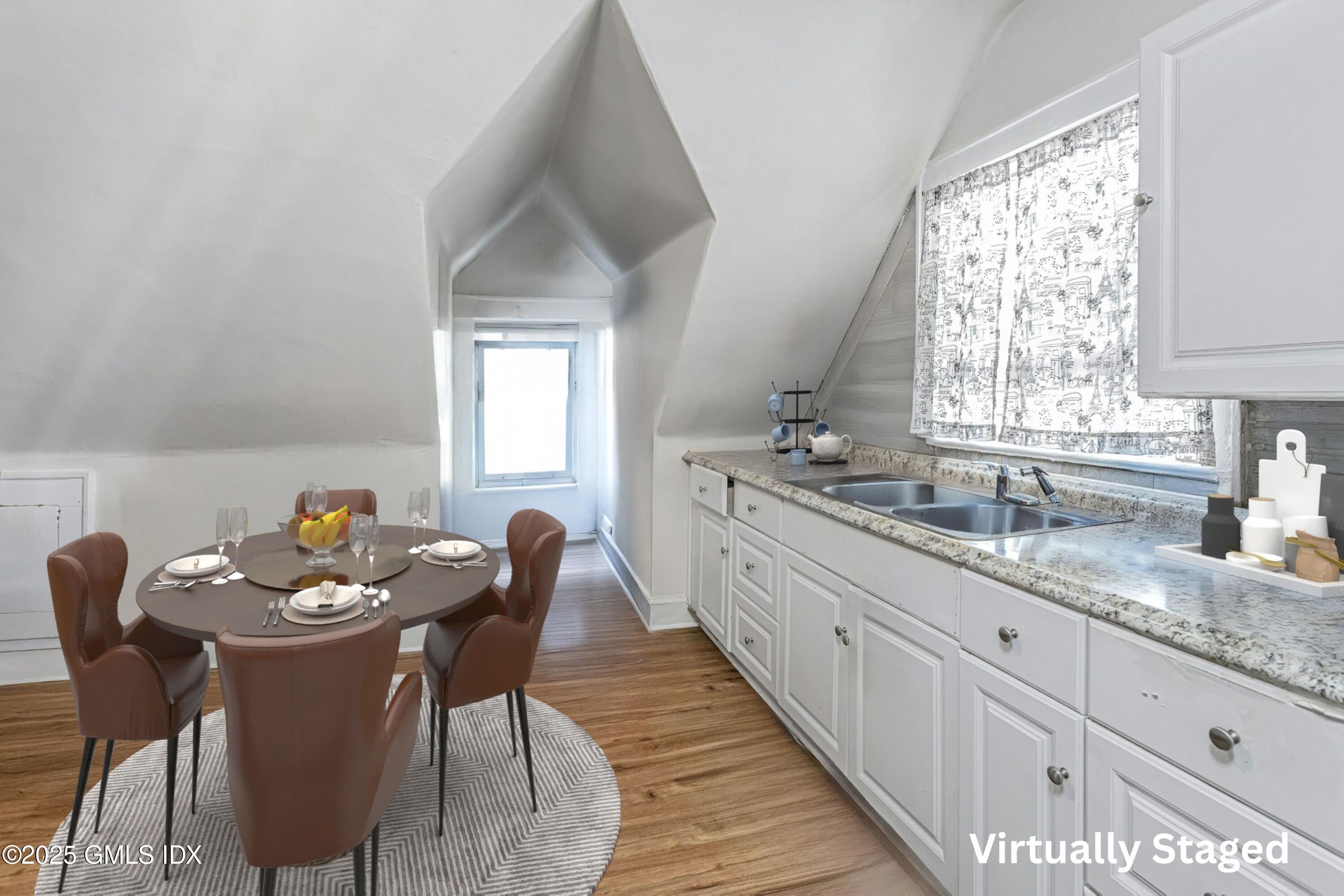 38 Alexander Street Greenwich, CT 06830 - Photo 20 of 36 a kitchen with stainless steel appliances granite countertop a white table chairs and a window