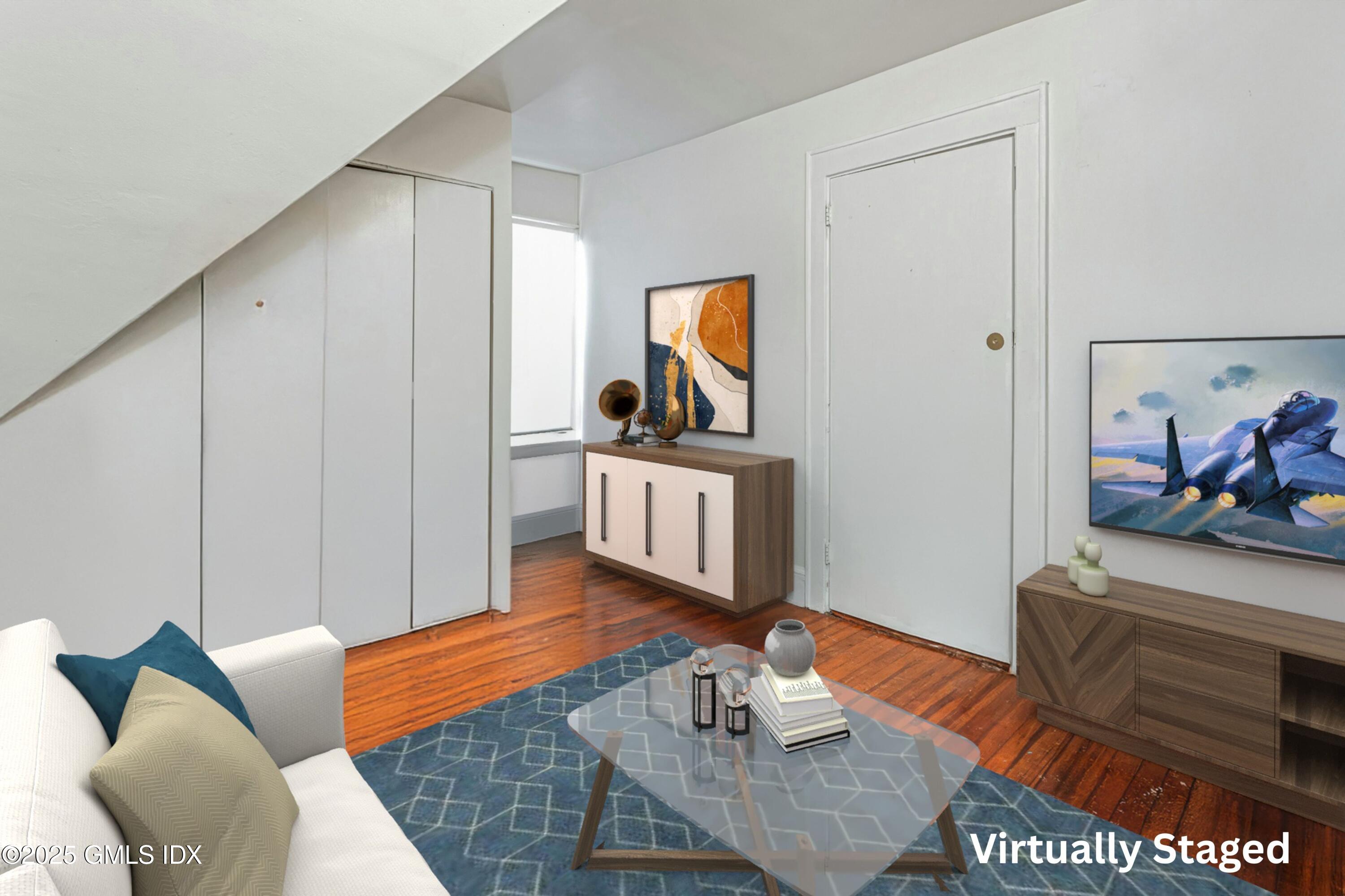 38 Alexander Street Greenwich, CT 06830 - Photo 24 of 36 a living room with furniture a rug and a painting on the wall