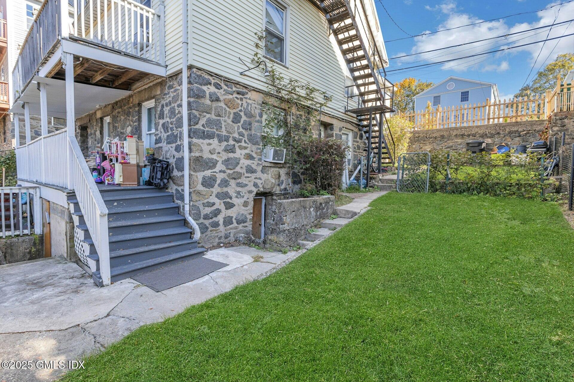 38 Alexander Street Greenwich, CT 06830 - Photo 30 of 36 a view of a building with a yard