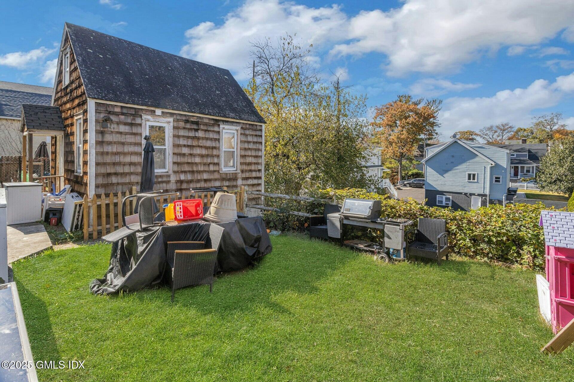 38 Alexander Street Greenwich, CT 06830 - Photo 32 of 36 a view of a house with backyard sitting area and garden