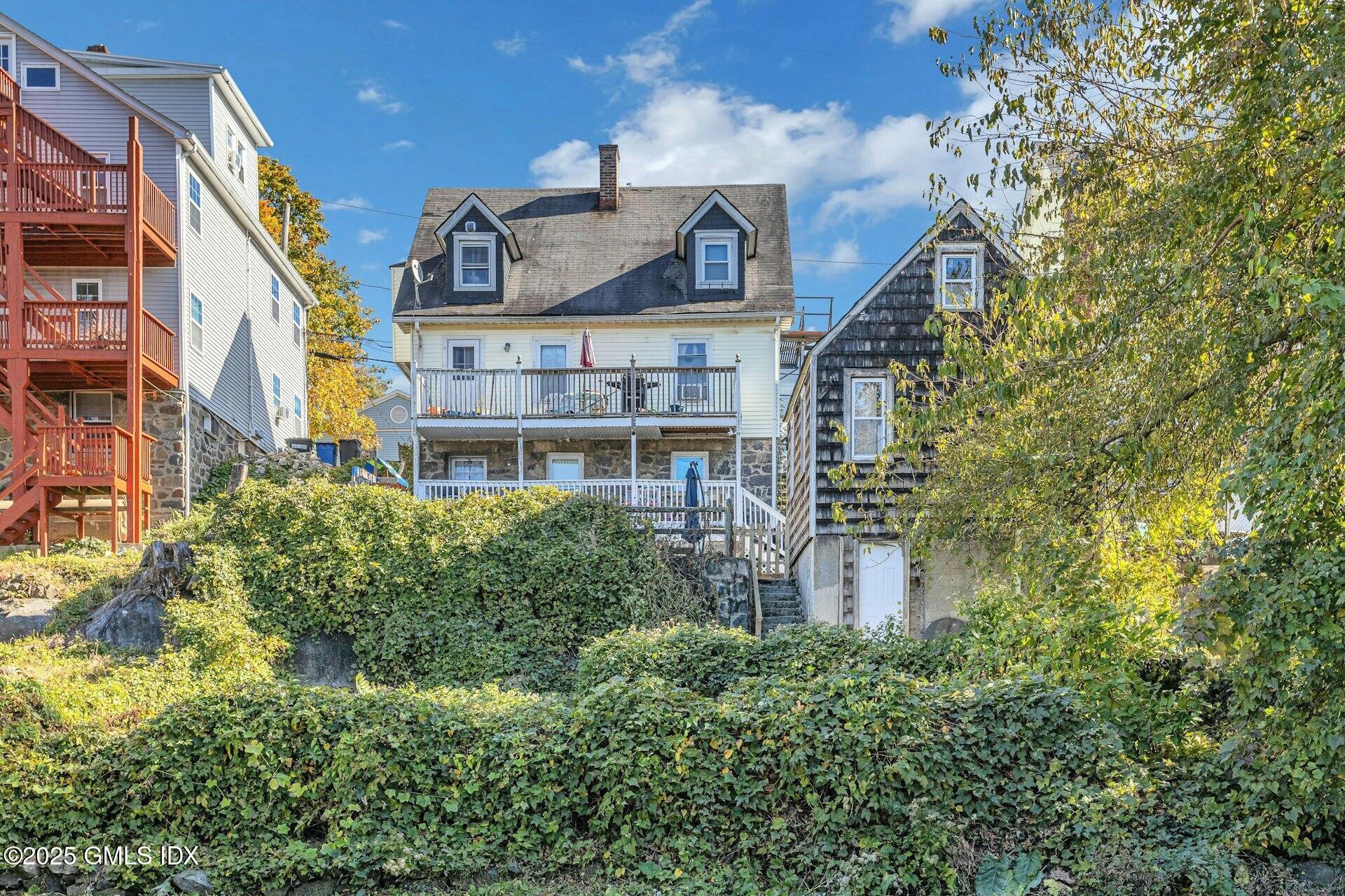 38 Alexander Street Greenwich, CT 06830 - Photo 33 of 36 a front view of a residential apartment building with a yard