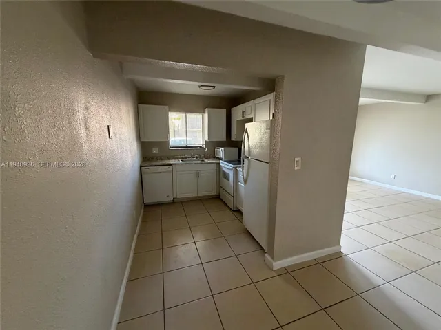 a kitchen with a cabinets and window