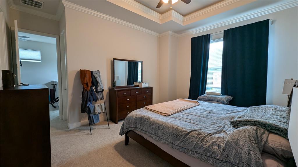 7476 Southwest 66th Lane Gainesville, FL 32608 - Photo 7 of 21 a bedroom with a bed and a flat tv screen on a dresser
