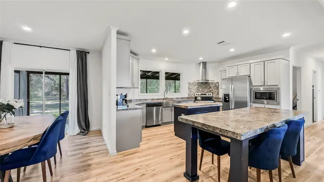 a kitchen with a wooden table and chairs