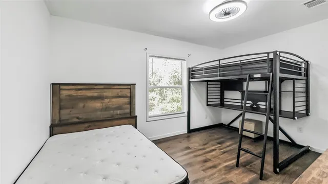 a bedroom with furniture and a window