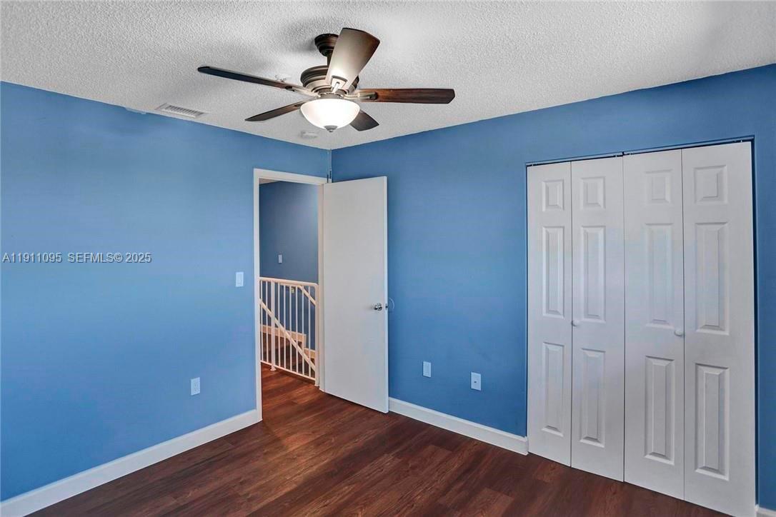 7755 West 30th Court, Unit E210 Hialeah, FL 33018 - Photo 11 of 14 a view of an empty room with wooden floor