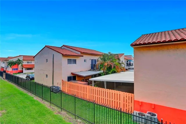 a view of a house with wooden fence