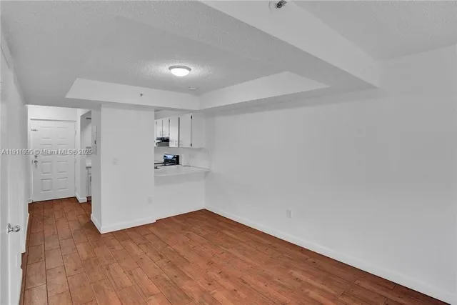 a view of a kitchen with wooden floor