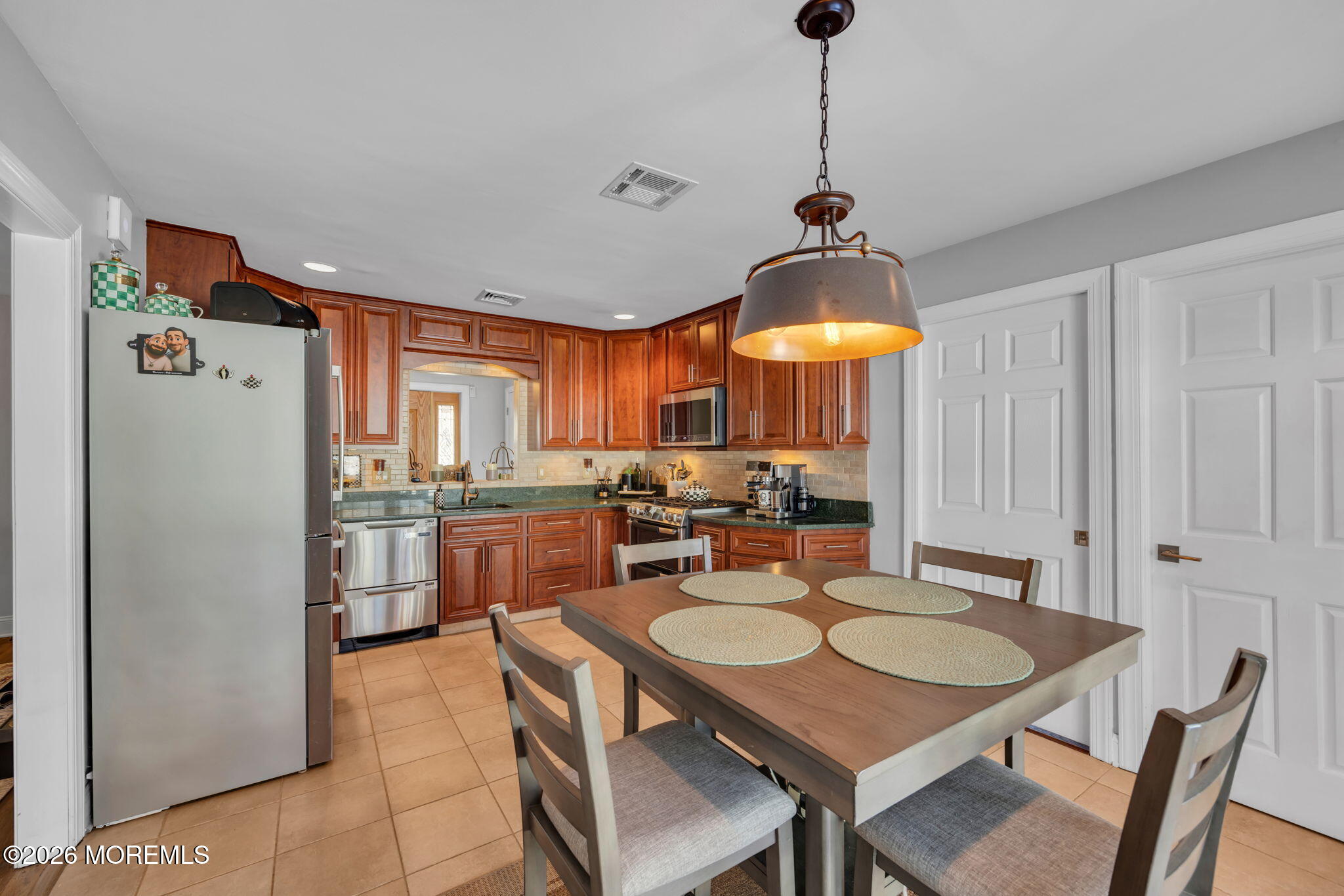 17 Idlebrook Lane Aberdeen, NJ 07747 - Photo 17 of 52 a table and chairs in a open kitchen