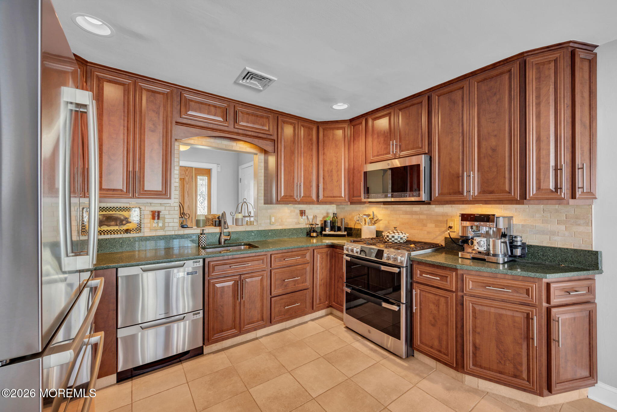 17 Idlebrook Lane Aberdeen, NJ 07747 - Photo 19 of 52 a kitchen with stainless steel appliances granite countertop wooden cabinets and a stove top oven
