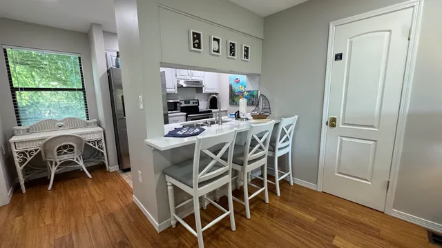 a view of a dining room with furniture window and wooden floor
