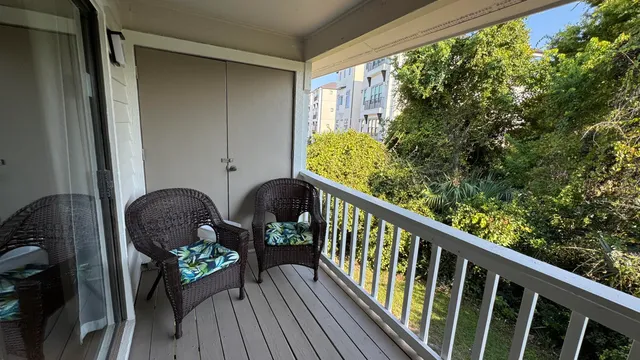 a balcony with wooden floor and furniture