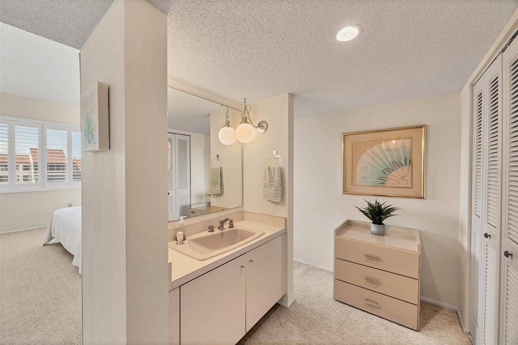 6285 Midnight Pass Road, Unit 403 Sarasota, FL 34242 - Photo 17 of 51 a bathroom with a double vanity sink a mirror and a shower