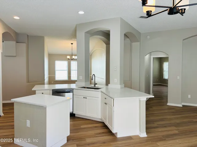 a view of living room with granite countertop cabinets and wooden floor