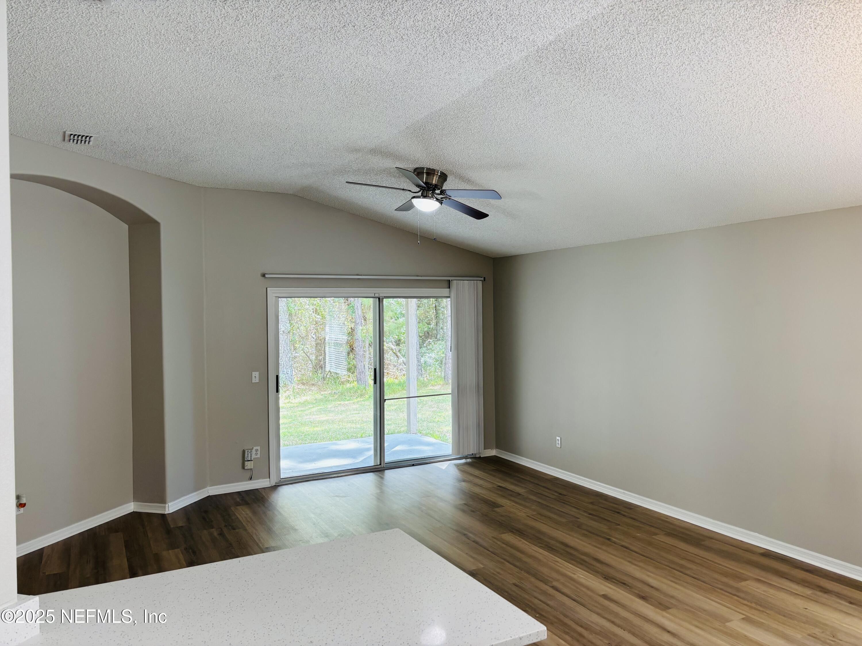 543 Longmill Lane Orange Park, FL 32065 - Photo 3 of 21 a view of an empty room with wooden floor and a window