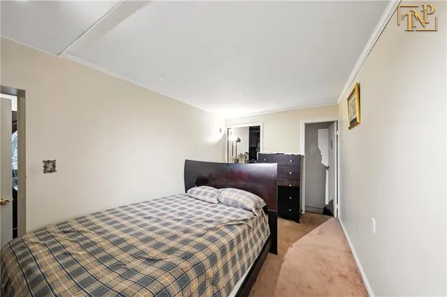 a bedroom with a bed and a mirror