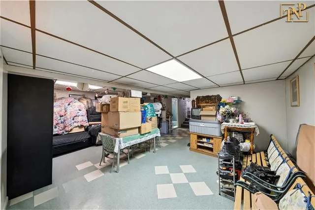 a living room with furniture a flat screen tv and gym equipment
