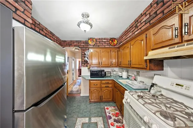 a kitchen with a stove a refrigerator and a sink