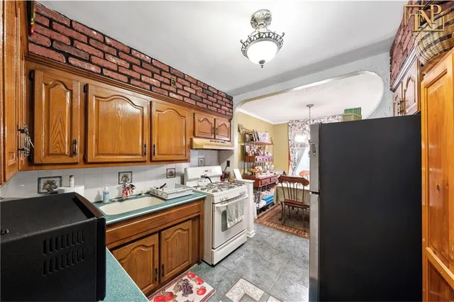 a kitchen with a refrigerator and a sink