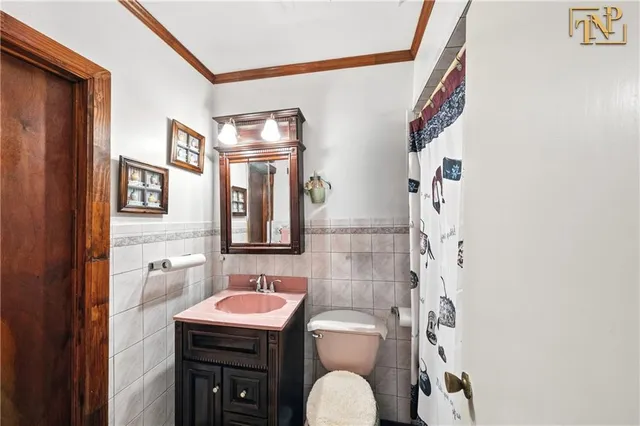 a bathroom with a sink a toilet and shower curtain