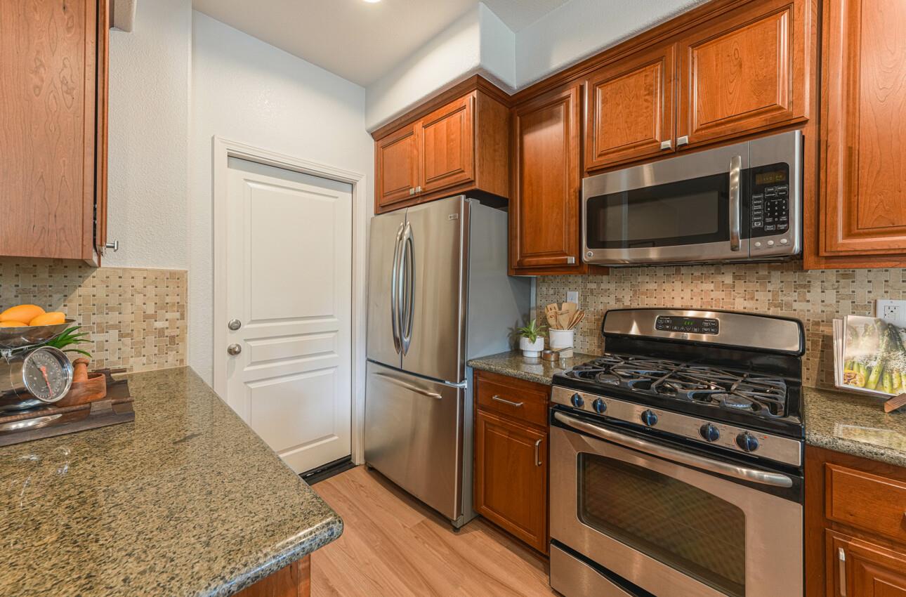 145 Atherton Loop Aptos, CA 95003 - Photo 14 of 47 a kitchen with stainless steel appliances granite countertop a stove microwave and refrigerator