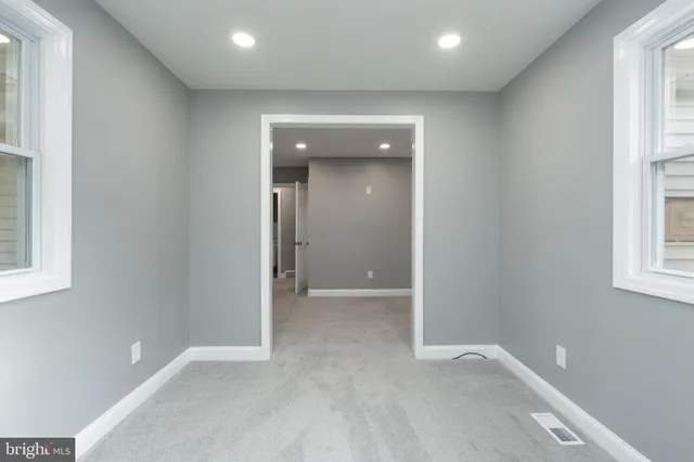 an empty room with closet and wooden floor