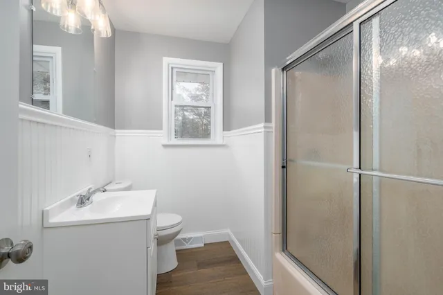 a bedroom with a bed and two windows