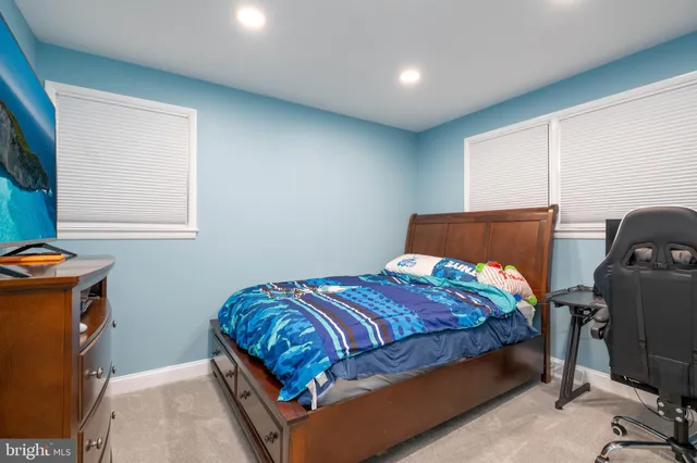 a bedroom with a bed and a view of living room