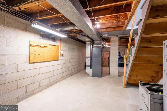 a view of water heater room with wooden floor