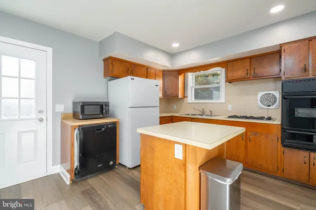 a kitchen with stainless steel appliances granite countertop refrigerator sink and stove