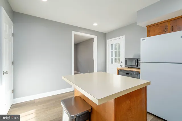 a kitchen with a table chairs and a refrigerator