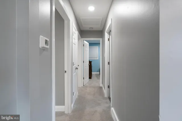 a view of a hallway with wooden shelves
