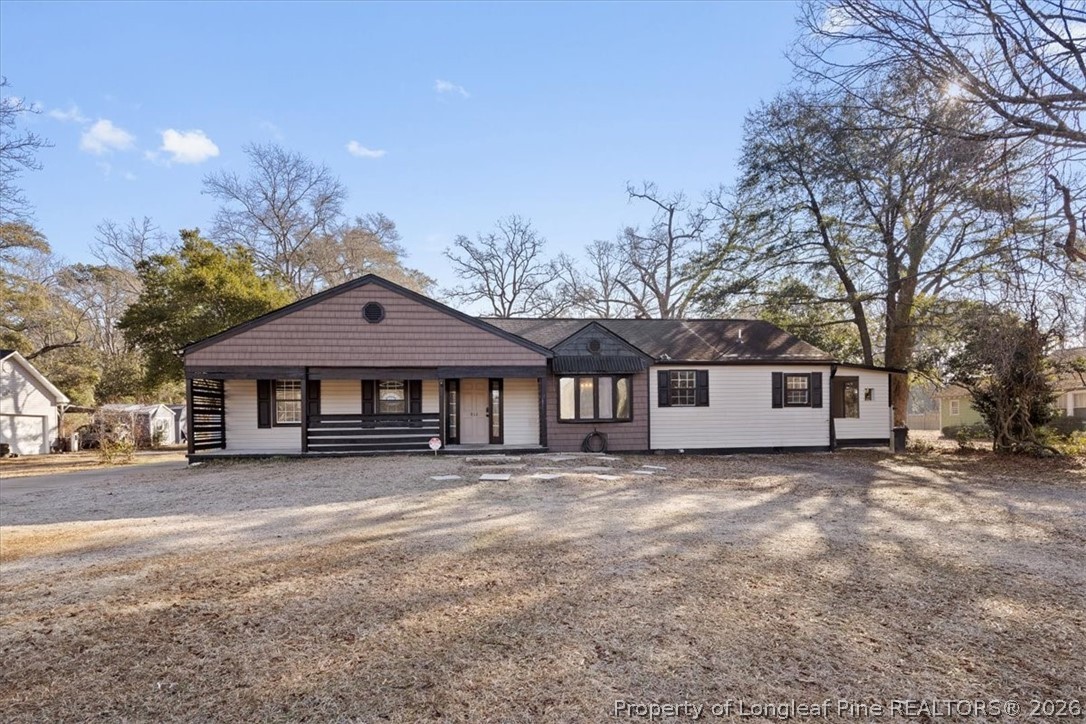 a house that has a tree in front of it