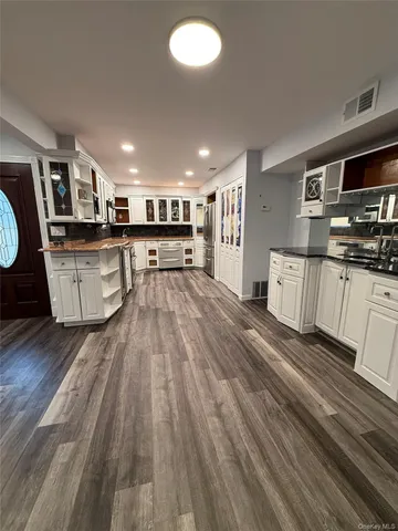a open kitchen with stainless steel appliances granite countertop a stove and a sink