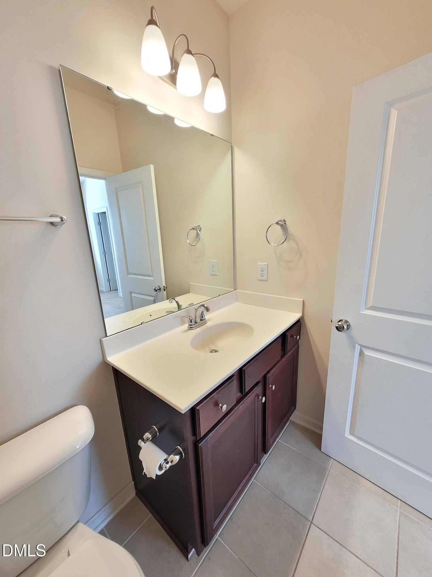 8951 Commons Townes Drive Raleigh, NC 27616 - Photo 22 of 40 a bathroom with a sink vanity and a mirror