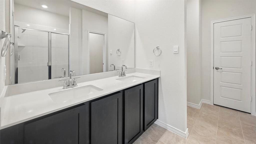 a bathroom with a double vanity sink and mirror