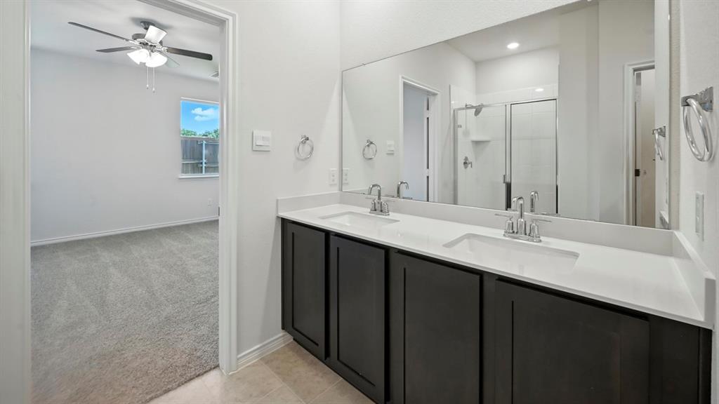 2345 Chloe Lane Anna, TX 75409 - Photo 2 of 36 a bathroom with a double vanity sink a mirror and a shower
