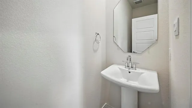 a spacious bathroom with a granite countertop sink a mirror and a vanity