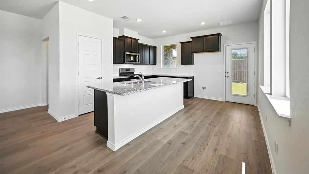 2345 Chloe Lane Anna, TX 75409 - Photo 23 of 36 a kitchen with a sink window and a refrigerator