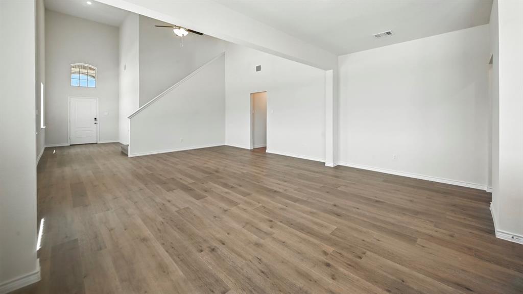 2345 Chloe Lane Anna, TX 75409 - Photo 34 of 36 a view of an empty room with wooden floor and stairs