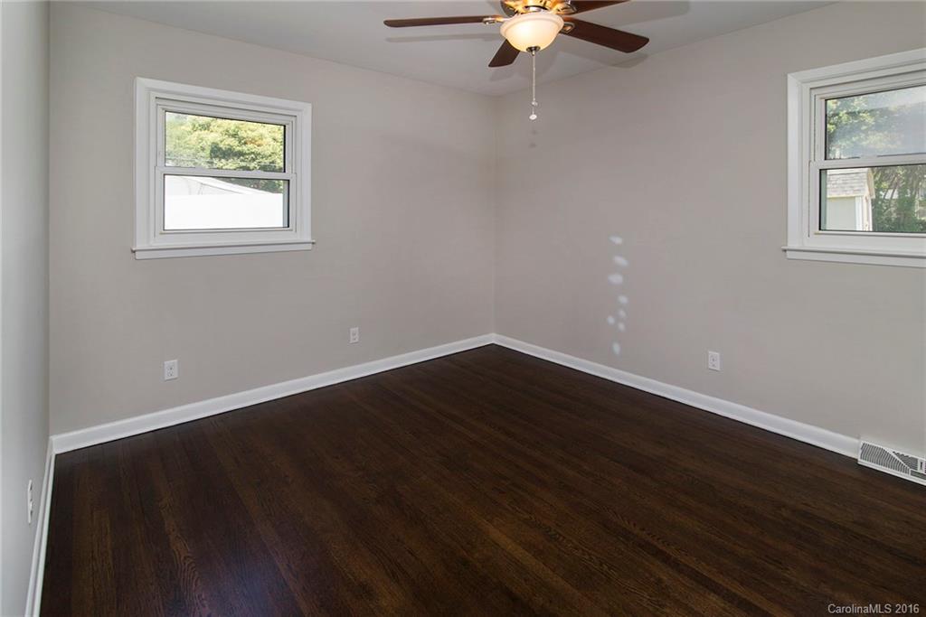 4209 Woodleaf Road Charlotte, NC 28205 - Photo 11 of 18 a view of an empty room with wooden floor and a window