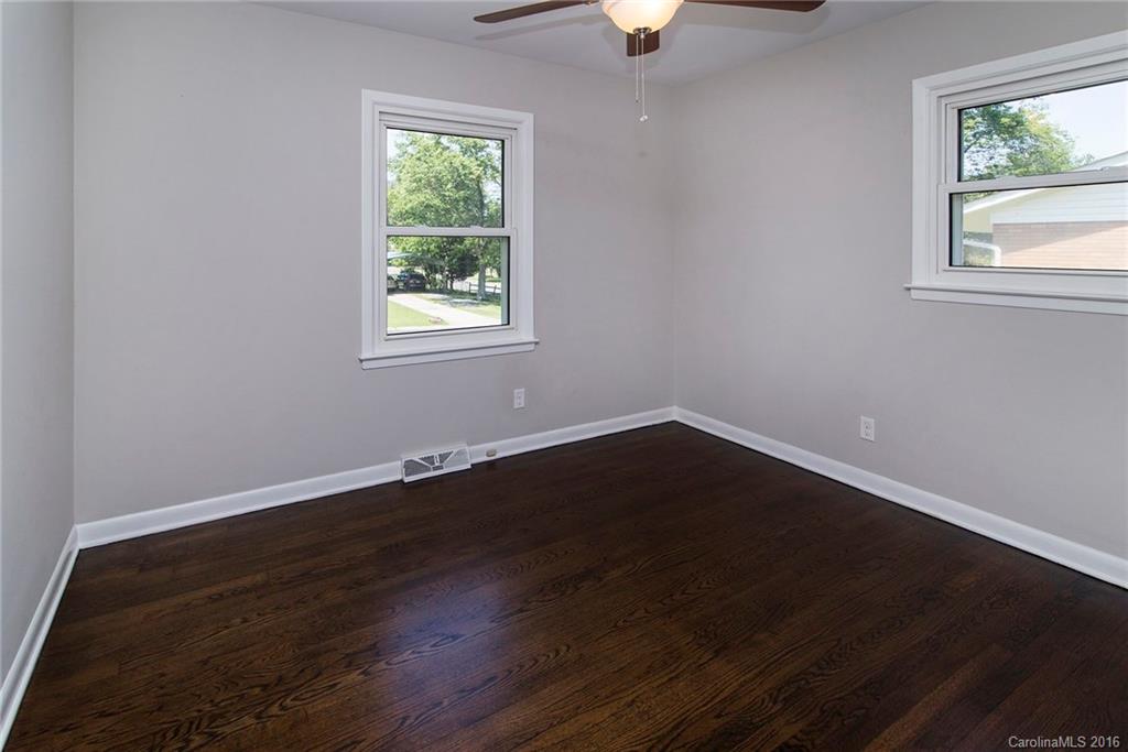 4209 Woodleaf Road Charlotte, NC 28205 - Photo 13 of 18 a view of an empty room with wooden floor and a window