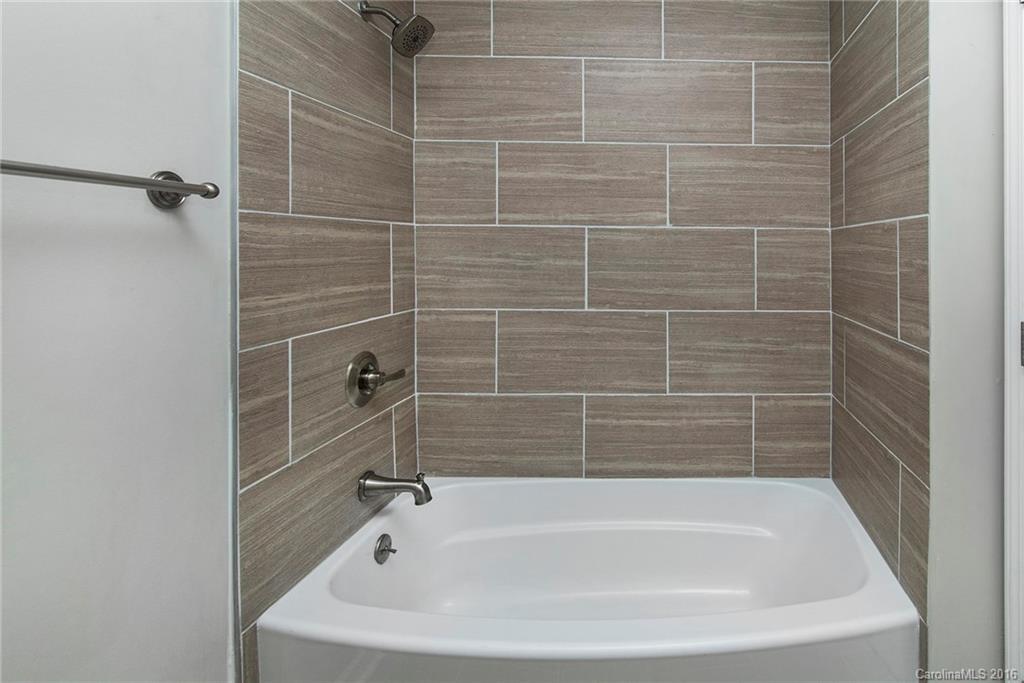 4209 Woodleaf Road Charlotte, NC 28205 - Photo 16 of 18 a white bath tub sitting next to a shower